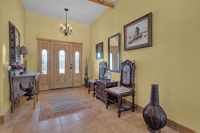 tiled entrance foyer featuring beam ceiling and a notable chandelier