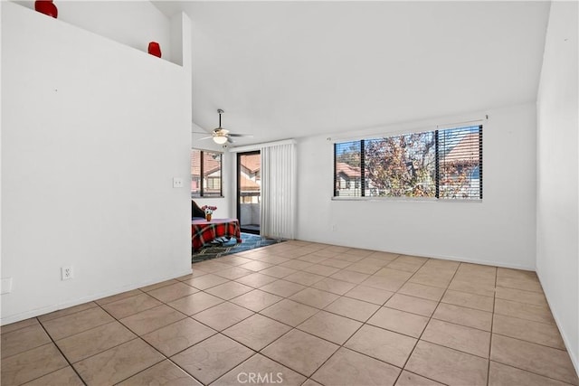 tiled spare room with high vaulted ceiling, ceiling fan, and a wealth of natural light