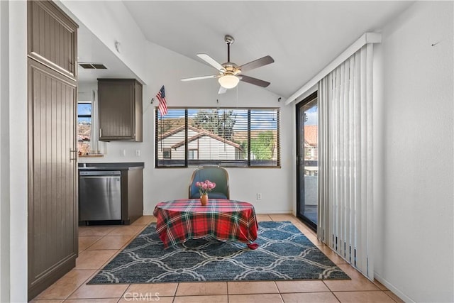 dining room featuring ceiling fan, light tile patterned floors, and vaulted ceiling