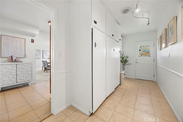 hall with light tile patterned floors