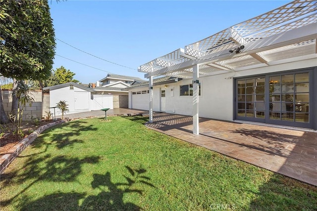 rear view of property with a pergola, a yard, and a patio