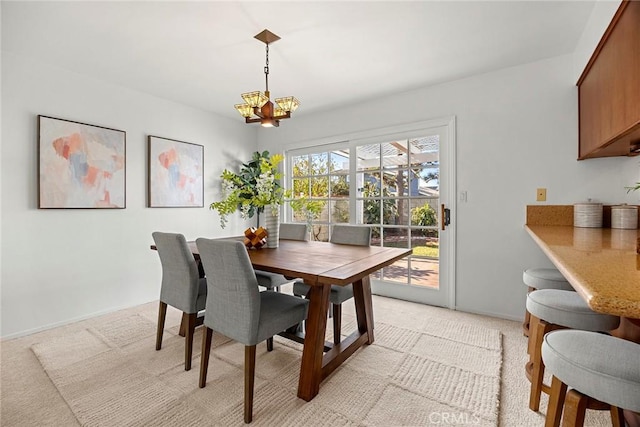 carpeted dining space with a notable chandelier