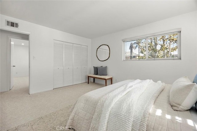 carpeted bedroom featuring a closet