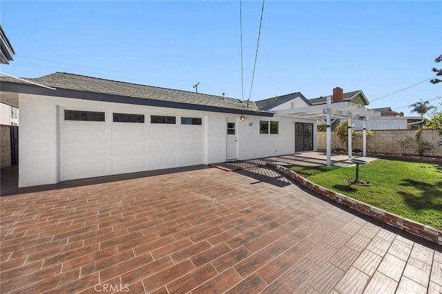 single story home featuring a garage, a pergola, and a front lawn