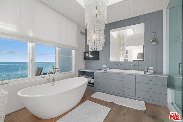 bathroom featuring hardwood / wood-style floors, vanity, independent shower and bath, and a notable chandelier