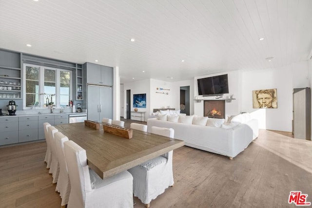 dining room featuring wood ceiling and light hardwood / wood-style flooring