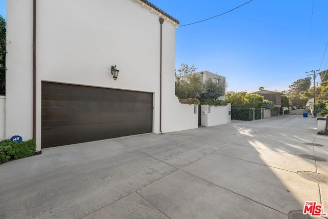 view of side of property with a garage