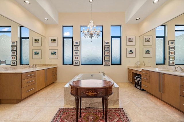 bathroom featuring a notable chandelier, plenty of natural light, and vanity