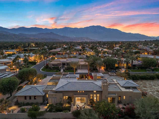 aerial view at dusk featuring a mountain view