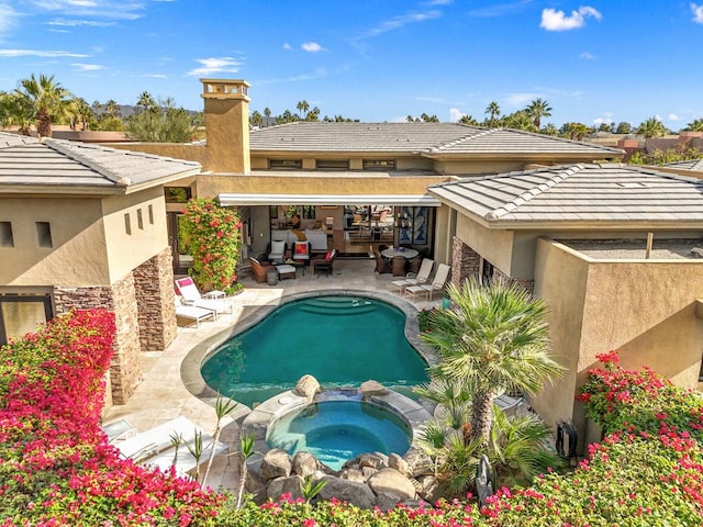 view of swimming pool with an in ground hot tub and a patio