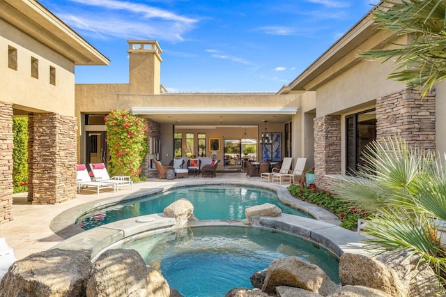 view of swimming pool featuring an in ground hot tub, an outdoor hangout area, and a patio area