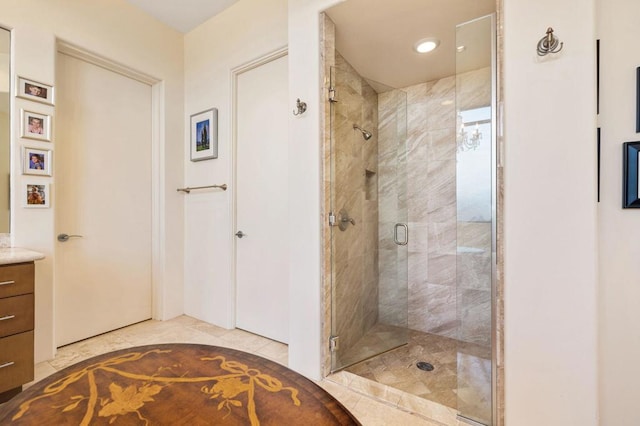 bathroom featuring tile patterned flooring, vanity, and a shower with shower door