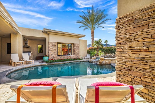 view of swimming pool with a patio area and pool water feature