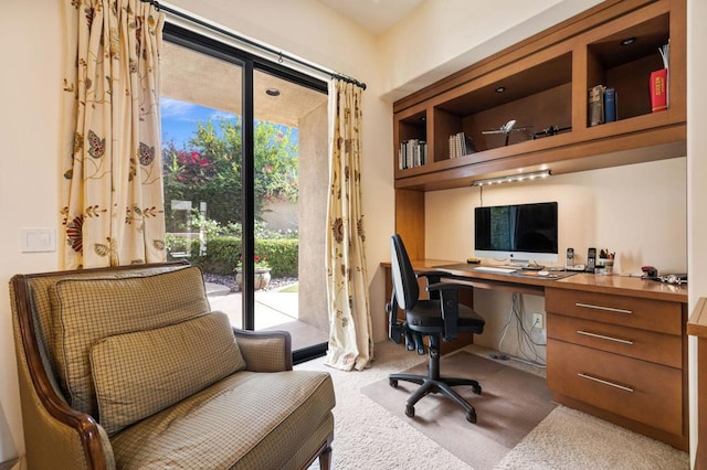 office area with a wealth of natural light and light colored carpet