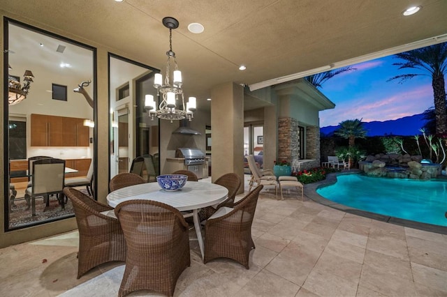 dining area featuring light tile patterned floors, a textured ceiling, and a notable chandelier