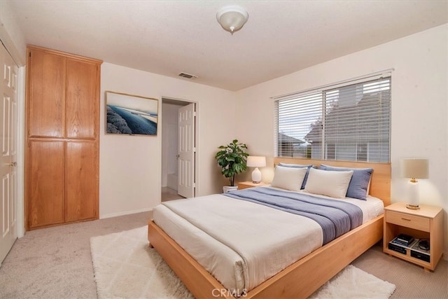 bedroom with light colored carpet