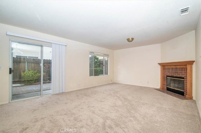 unfurnished living room featuring a fireplace and carpet flooring