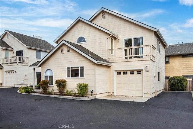 view of property with a balcony and a garage