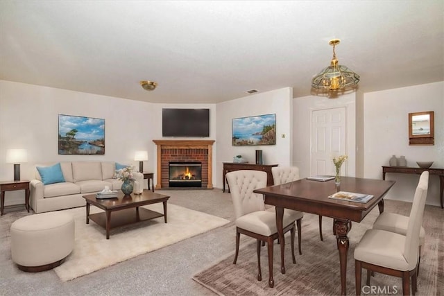 living room featuring carpet floors and a brick fireplace