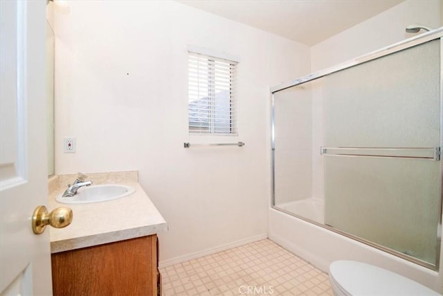 full bathroom with vanity, toilet, and combined bath / shower with glass door