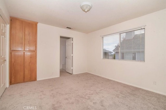 unfurnished bedroom with light colored carpet