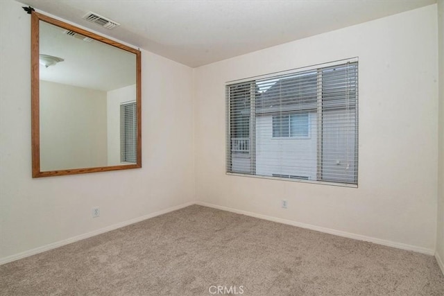 unfurnished room featuring light colored carpet