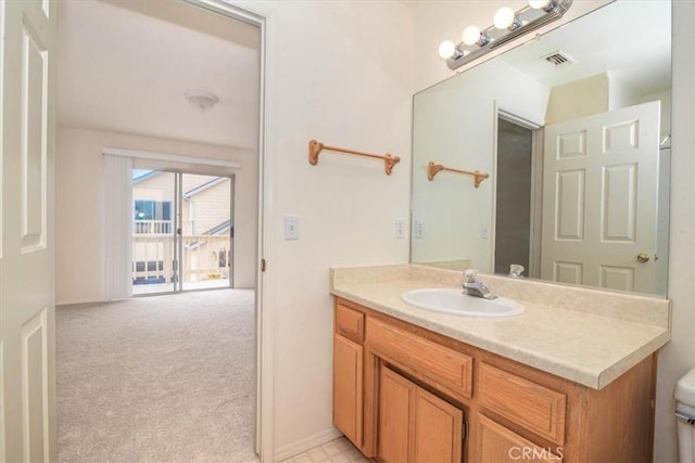 bathroom featuring vanity and toilet