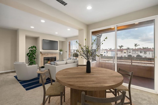 carpeted dining area with a wealth of natural light