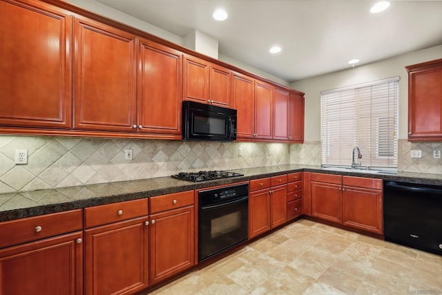 kitchen featuring black appliances, decorative backsplash, and sink