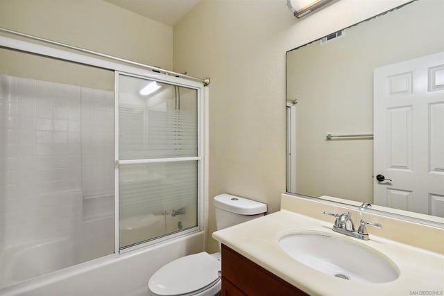 full bathroom with shower / bath combination with glass door, vanity, and toilet