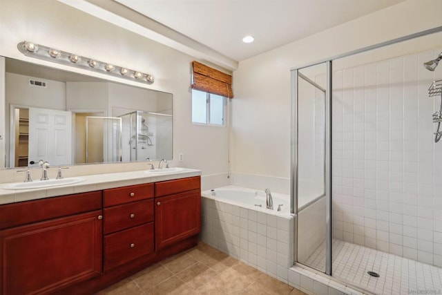 bathroom with tile patterned floors, vanity, and separate shower and tub