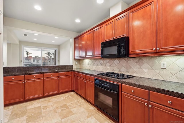 kitchen with black appliances and tasteful backsplash