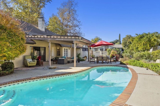 view of pool featuring an outdoor living space and a patio area