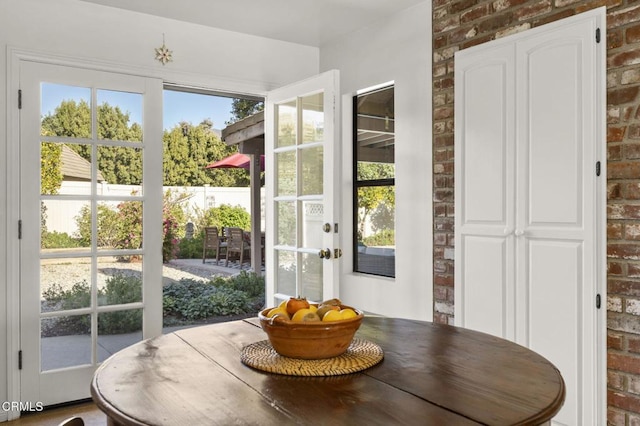 dining area featuring brick wall