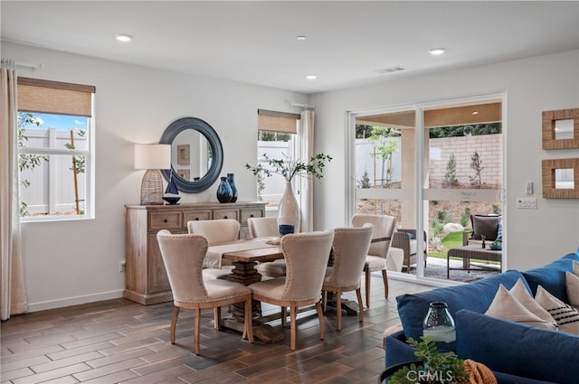 dining space with dark hardwood / wood-style flooring and a healthy amount of sunlight