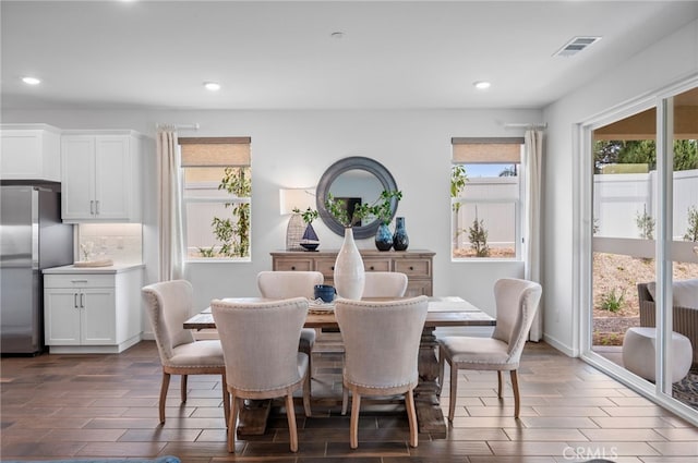 dining space with dark hardwood / wood-style floors