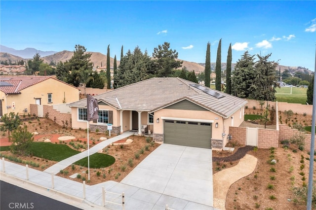 view of front of house with a mountain view and a garage