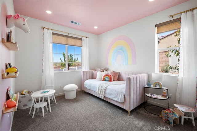 bedroom with carpet and multiple windows