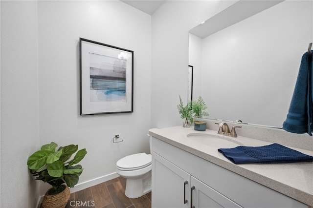 bathroom featuring hardwood / wood-style floors, vanity, and toilet