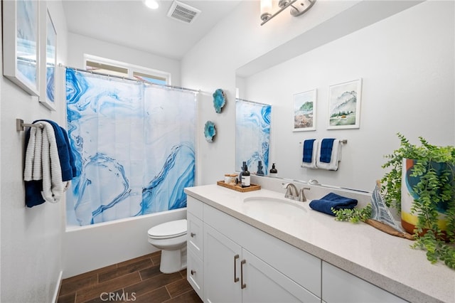 full bathroom featuring hardwood / wood-style floors, vanity, toilet, and shower / bath combination with curtain