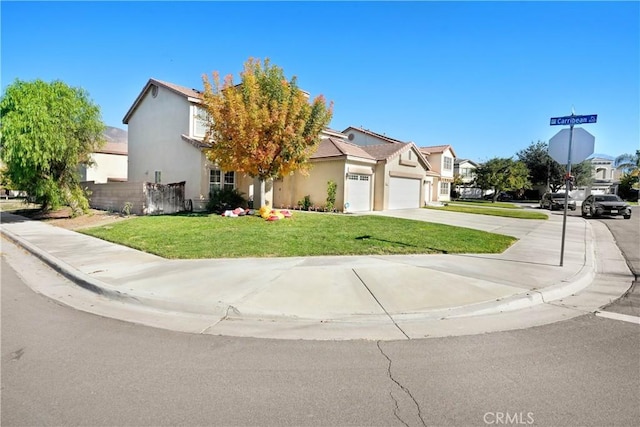 view of front of house with a garage and a front lawn