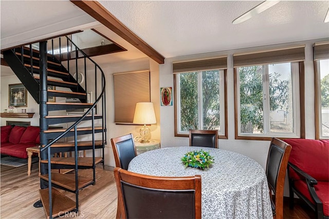 dining space featuring a textured ceiling and hardwood / wood-style flooring