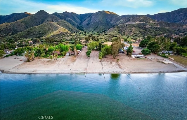 exterior space with a water and mountain view