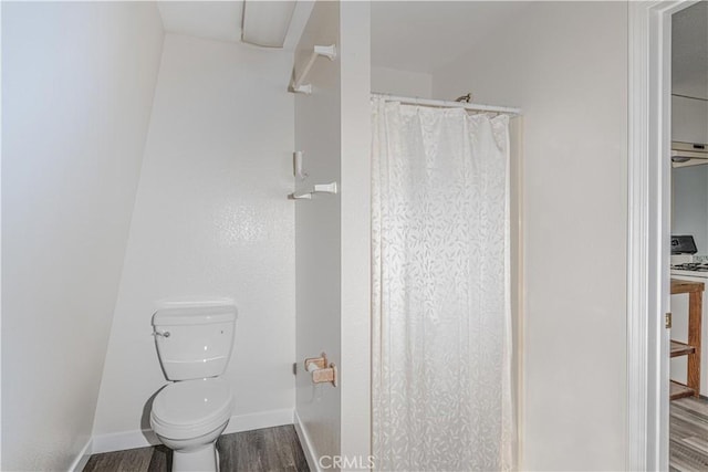 bathroom with wood-type flooring and toilet