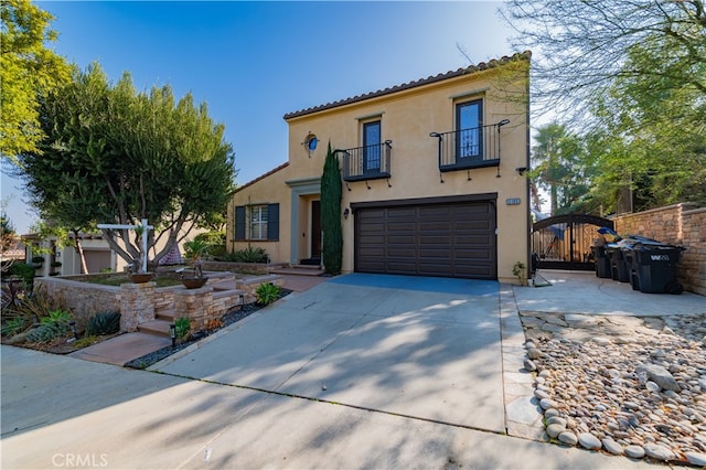 5185 Highview St, Chino Hills, CA 91709 - mediterranean / spanish-style home featuring a balcony, a garage, stucco siding, a gate, and driveway