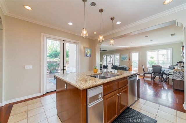 5185 Highview St, Chino Hills, CA 91709 - kitchen featuring open floor plan, brown cabinets, plenty of natural light, a kitchen island with sink, and ornamental molding