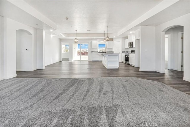 unfurnished living room featuring dark wood-type flooring