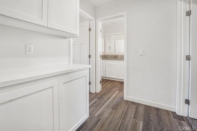 hallway featuring dark hardwood / wood-style flooring and sink