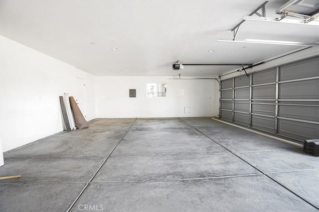 garage featuring a garage door opener and electric panel