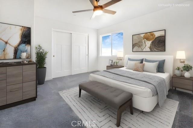 bedroom with ceiling fan, dark carpet, and a closet